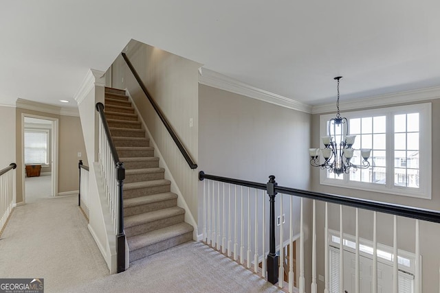 stairway featuring ornamental molding, a healthy amount of sunlight, carpet flooring, and an inviting chandelier