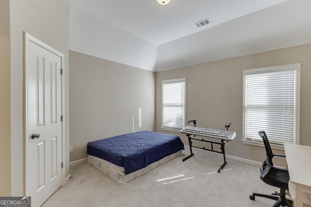 carpeted bedroom featuring vaulted ceiling, visible vents, and baseboards