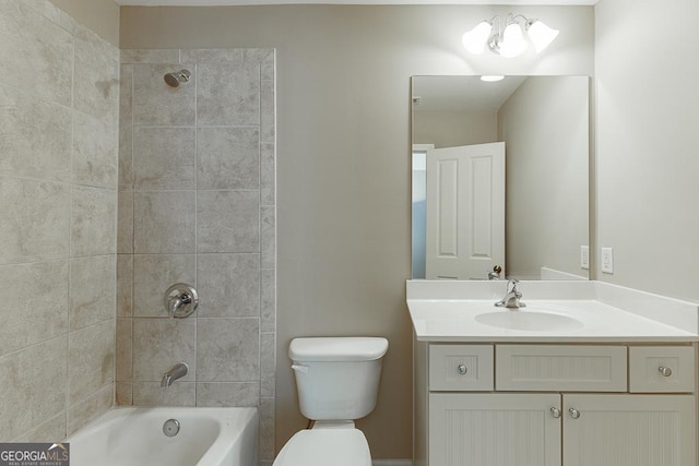 bathroom featuring toilet, tub / shower combination, and vanity