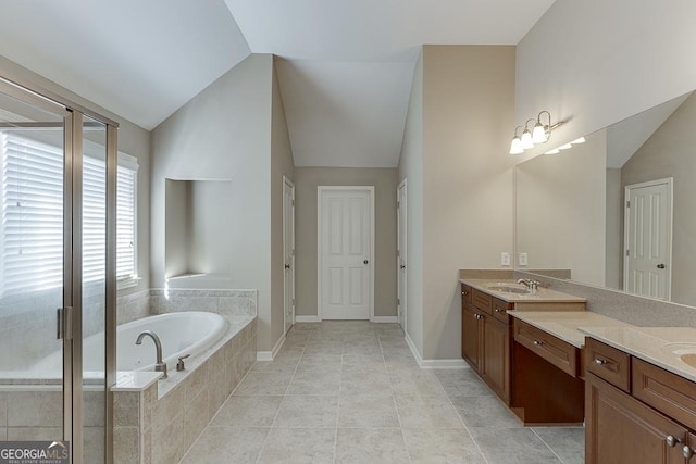 bathroom with lofted ceiling, tile patterned flooring, a bath, and vanity