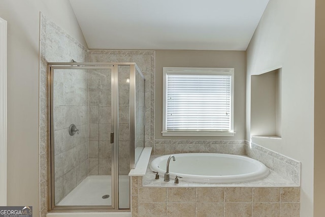 bathroom featuring lofted ceiling, a shower stall, and a bath