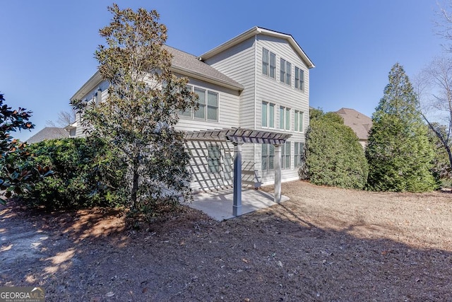 view of front of home featuring a patio area and a pergola