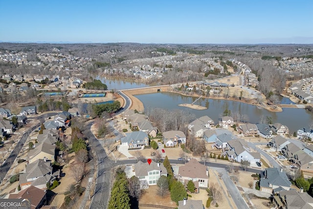 bird's eye view featuring a water view and a residential view