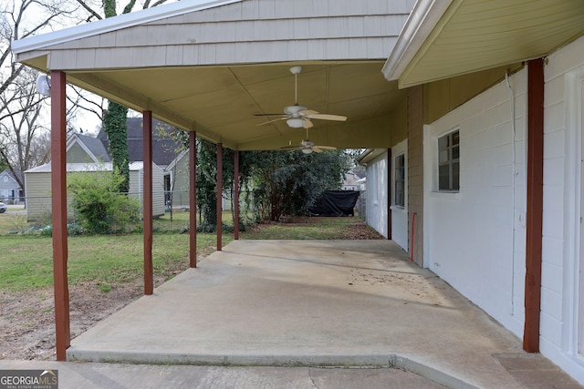 view of patio with a carport, fence, and a ceiling fan