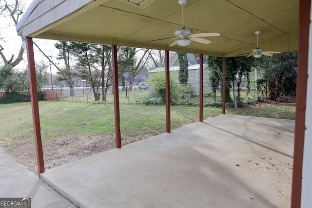 view of patio with ceiling fan and fence