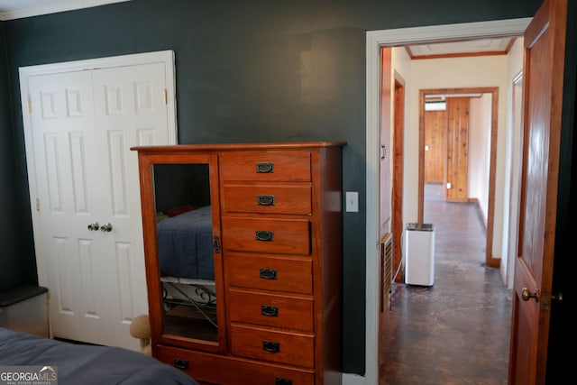 bedroom featuring concrete flooring and a closet