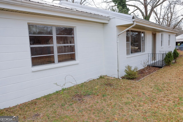 view of home's exterior with a yard and metal roof