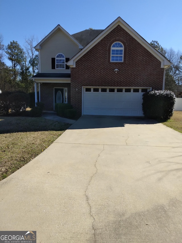 traditional home with driveway and brick siding