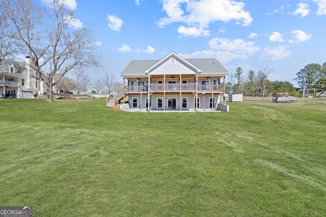 rear view of property featuring stairway, a lawn, a wooden deck, and a ceiling fan