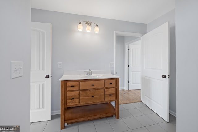 bathroom with tile patterned flooring, vanity, and baseboards