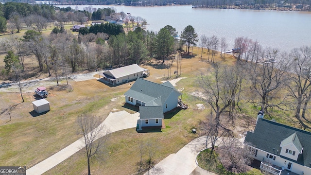 birds eye view of property with a water view