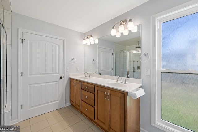 full bathroom featuring double vanity, tile patterned flooring, a sink, and a shower stall