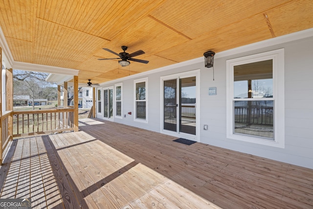 wooden deck featuring ceiling fan