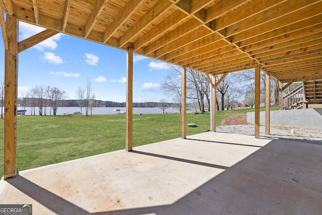 view of patio / terrace featuring a water view and stairway