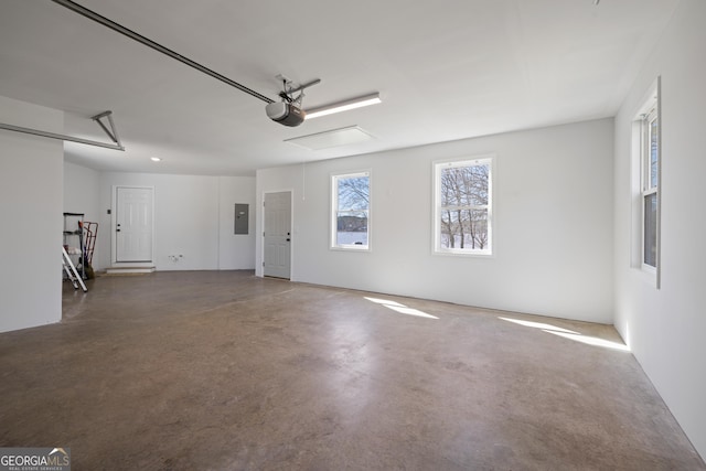 garage with electric panel and a garage door opener