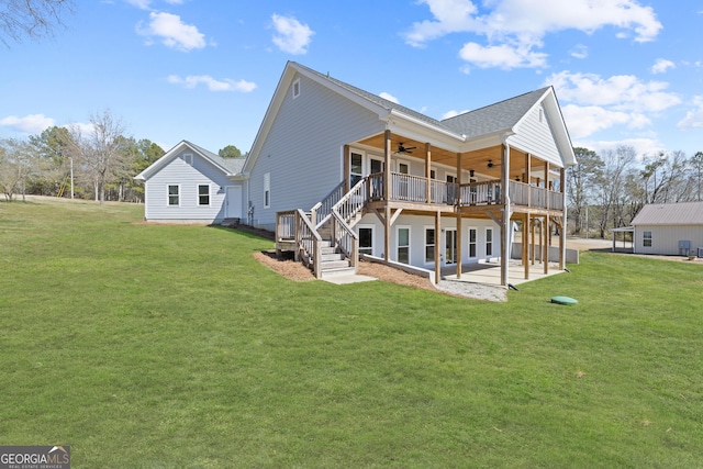 back of house featuring a patio, a yard, a wooden deck, and a ceiling fan