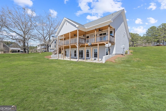 back of property featuring ceiling fan, a lawn, a deck, and a patio