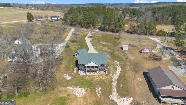 birds eye view of property with a rural view