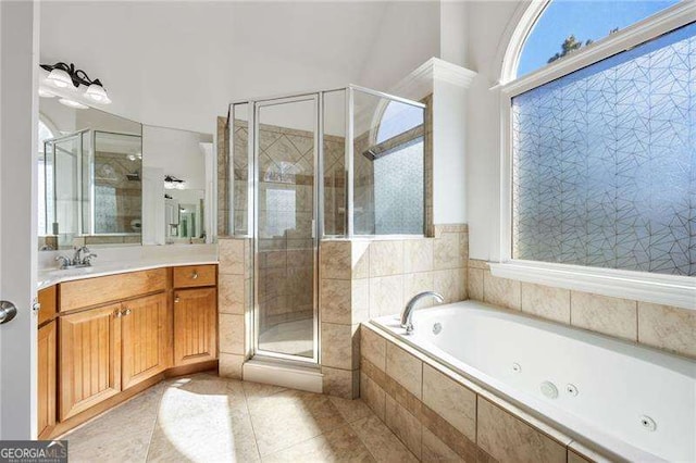 bathroom with tile patterned flooring, a shower stall, a whirlpool tub, and vanity