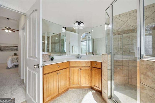 ensuite bathroom featuring connected bathroom, a shower stall, vanity, and ceiling fan