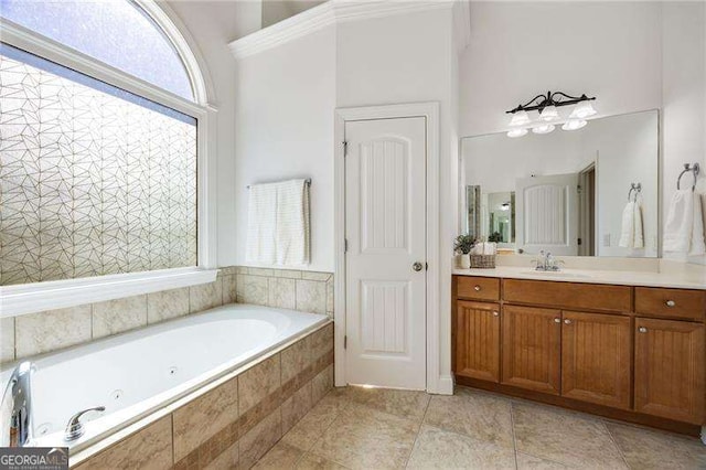 bathroom featuring a jetted tub, vanity, and tile patterned floors