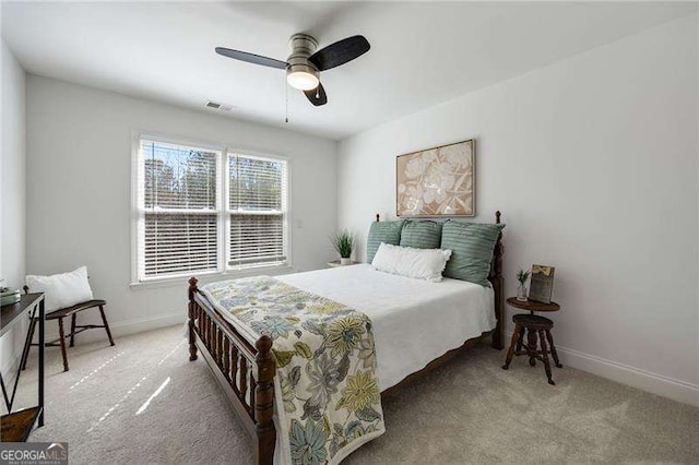 carpeted bedroom featuring visible vents, a ceiling fan, and baseboards