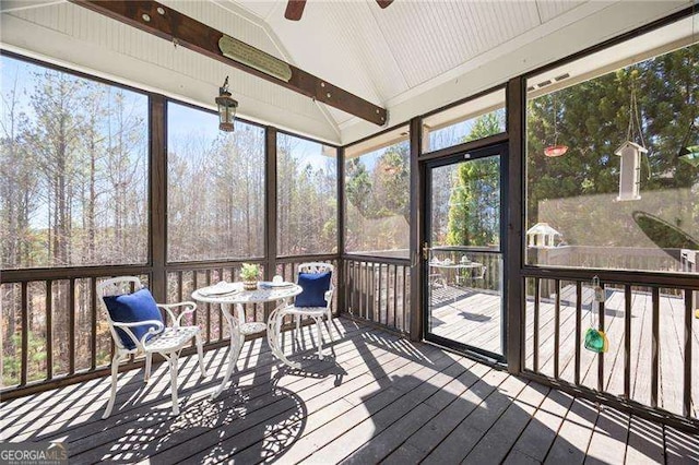 sunroom / solarium with a ceiling fan and lofted ceiling