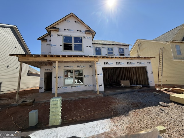 property in mid-construction featuring a garage and gravel driveway