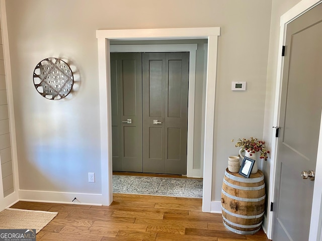 entrance foyer with baseboards and wood finished floors