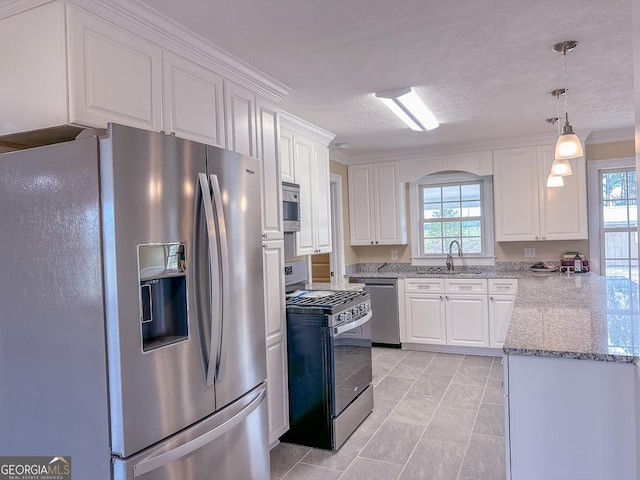 kitchen with stainless steel appliances, a wealth of natural light, and white cabinetry