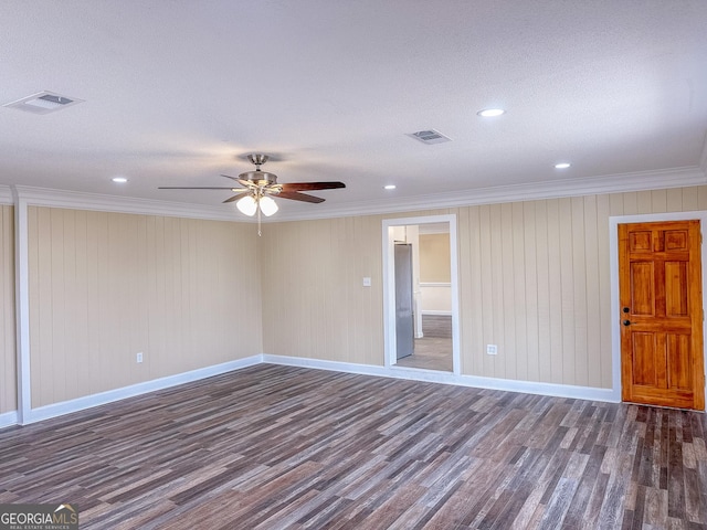 unfurnished room with ornamental molding, visible vents, baseboards, and wood finished floors