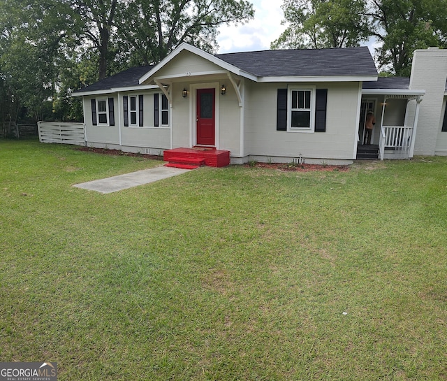 ranch-style house featuring fence and a front yard