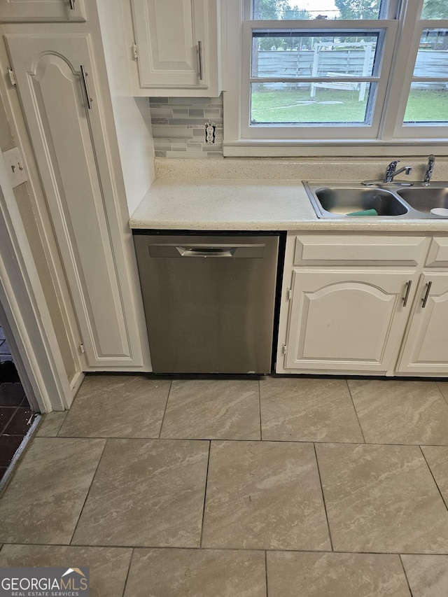 kitchen with light countertops, a healthy amount of sunlight, dishwasher, and a sink