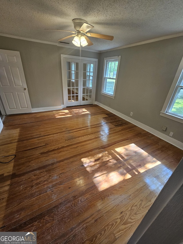 interior space featuring hardwood / wood-style flooring, a wealth of natural light, and crown molding