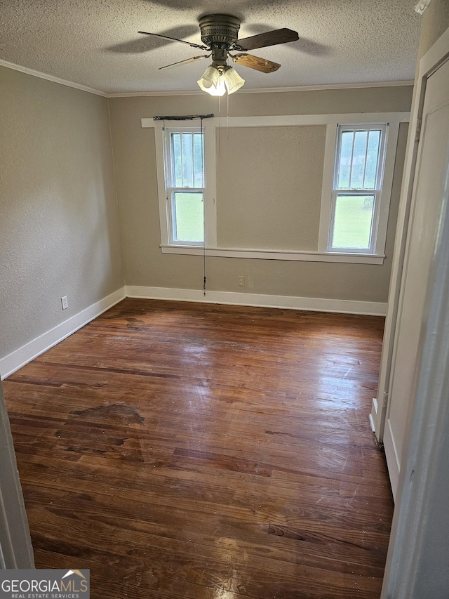 unfurnished room featuring a textured ceiling, ceiling fan, ornamental molding, and wood finished floors