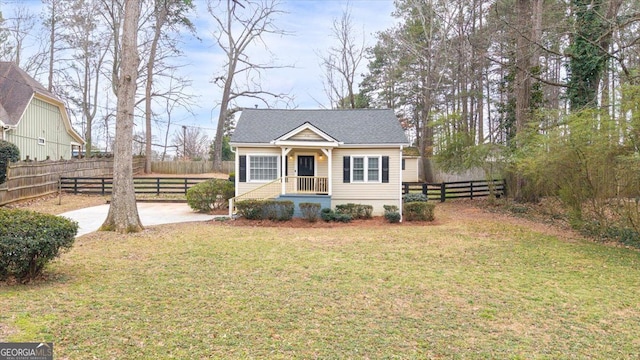 bungalow-style home featuring a front yard and fence