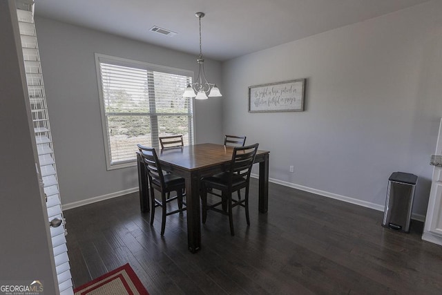 dining area with dark wood-style flooring, visible vents, and baseboards