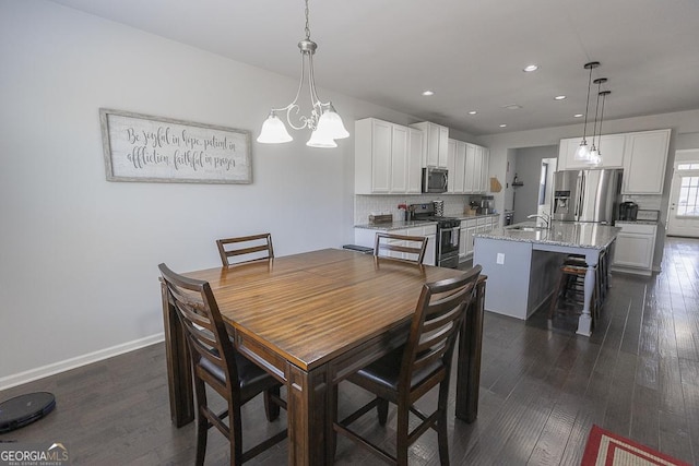 dining room featuring baseboards, dark wood-style flooring, and recessed lighting