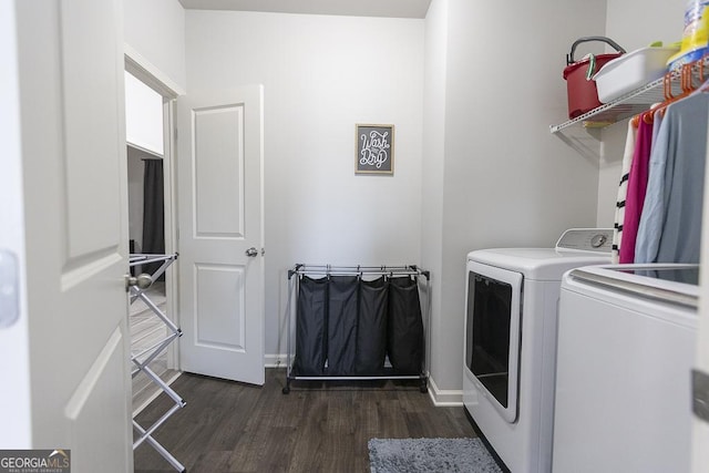 laundry area featuring dark wood-type flooring, washer and dryer, laundry area, and baseboards