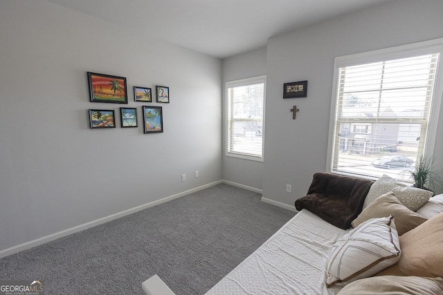 carpeted living room with baseboards