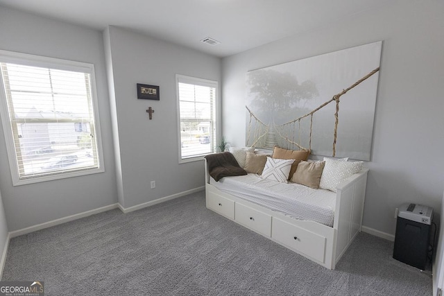 carpeted bedroom featuring visible vents and baseboards