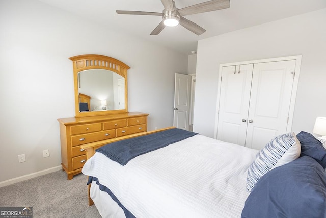 bedroom featuring a closet, light colored carpet, ceiling fan, and baseboards