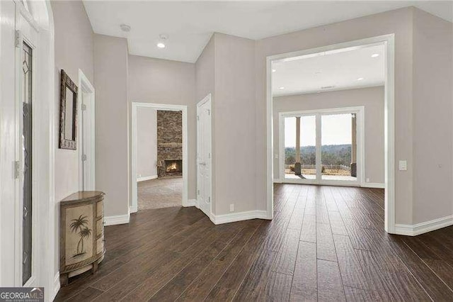 hall with dark wood-style floors, recessed lighting, and baseboards