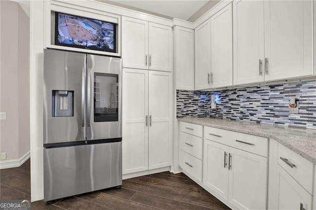 kitchen featuring decorative backsplash, dark wood-type flooring, light stone countertops, white cabinetry, and stainless steel refrigerator with ice dispenser