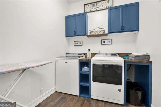 washroom with dark wood-style floors, baseboards, cabinet space, and washing machine and clothes dryer