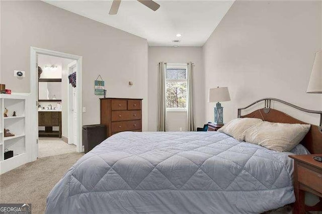 bedroom with carpet floors, ensuite bathroom, and a ceiling fan