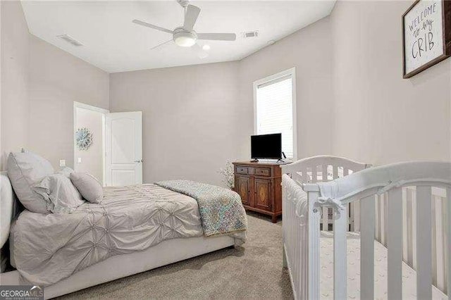 bedroom featuring light colored carpet, ceiling fan, and visible vents