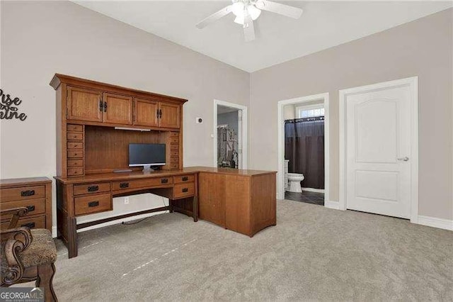 office area with light colored carpet, ceiling fan, and baseboards