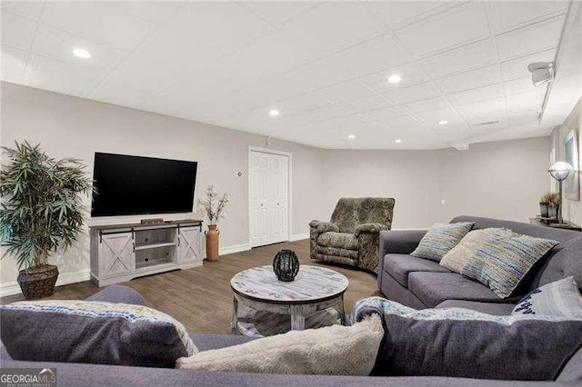 living area with recessed lighting, wood finished floors, and baseboards