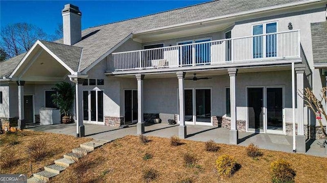 rear view of property with french doors, a patio, and stucco siding